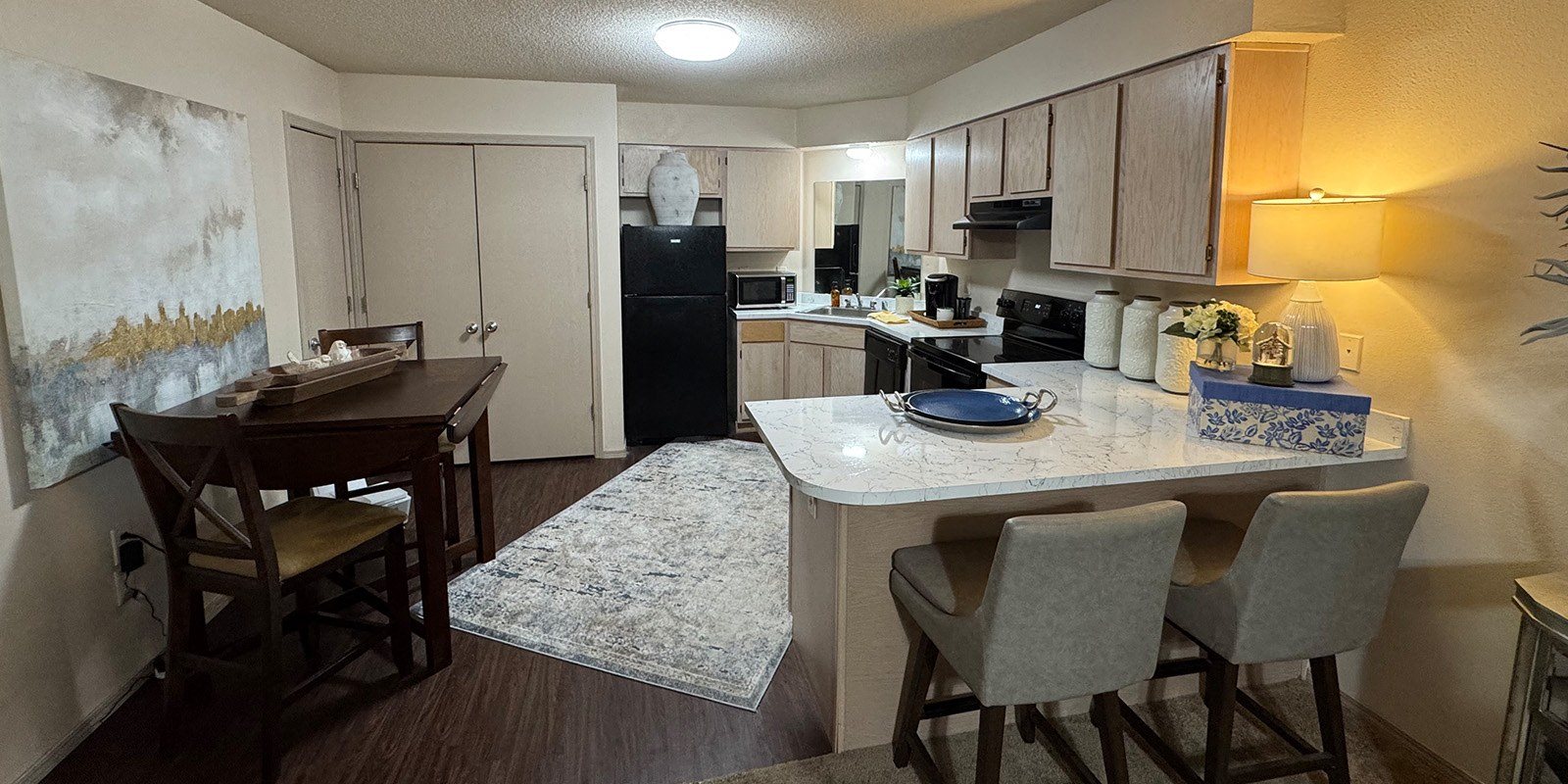 A kitchen with a table and chairs in the middle of the room.
